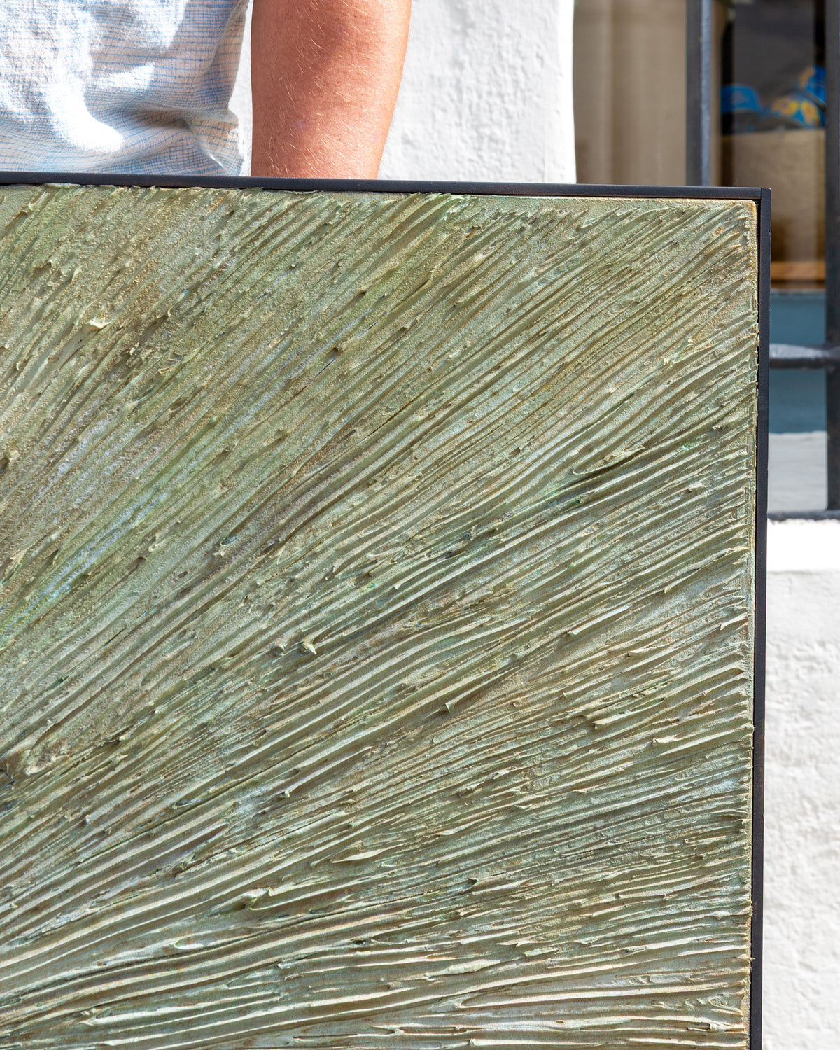 Top right corner of the painting, impasto rays in sage and sand meeting the black frame edge.