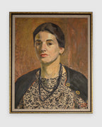 Straight-on view of a Priscilla Bender-Shore 1963 self portrait in a navy jacket and beaded necklace on burnt orange, in a gilt frame, on a light gray background.
