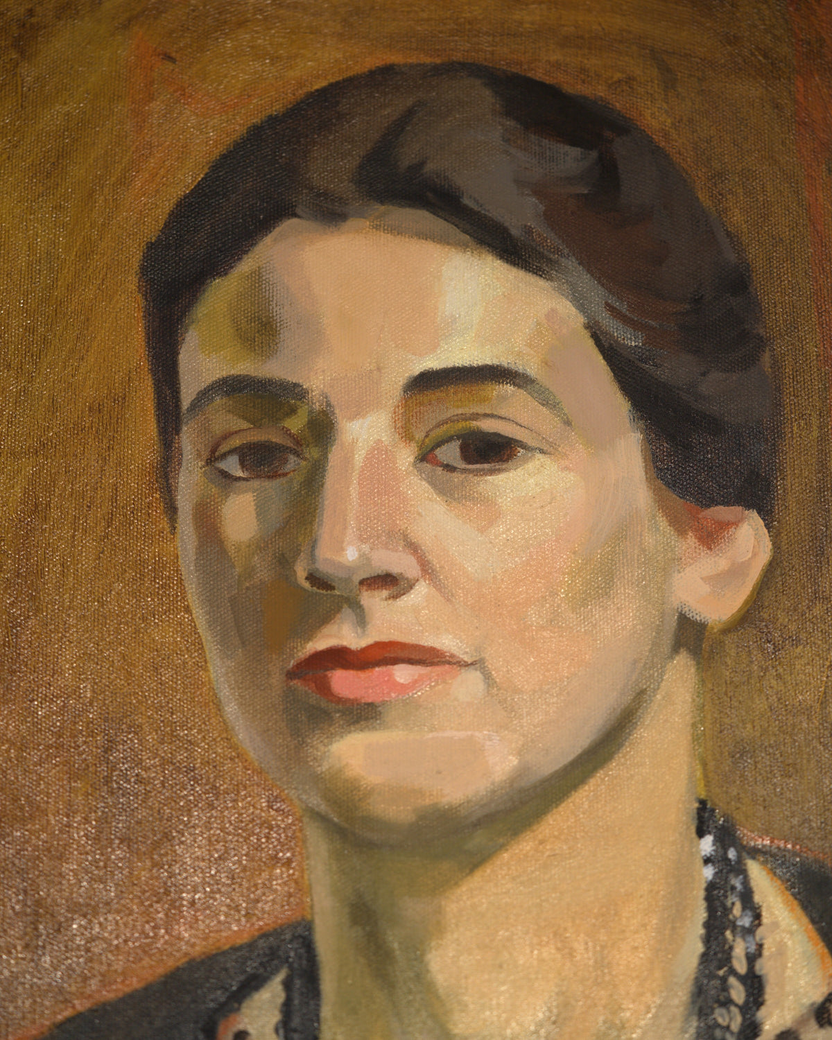 Close detail (face) of the Priscilla Bender-Shore 1963 self portrait in a navy jacket and beaded necklace on burnt orange, in a gilt frame.