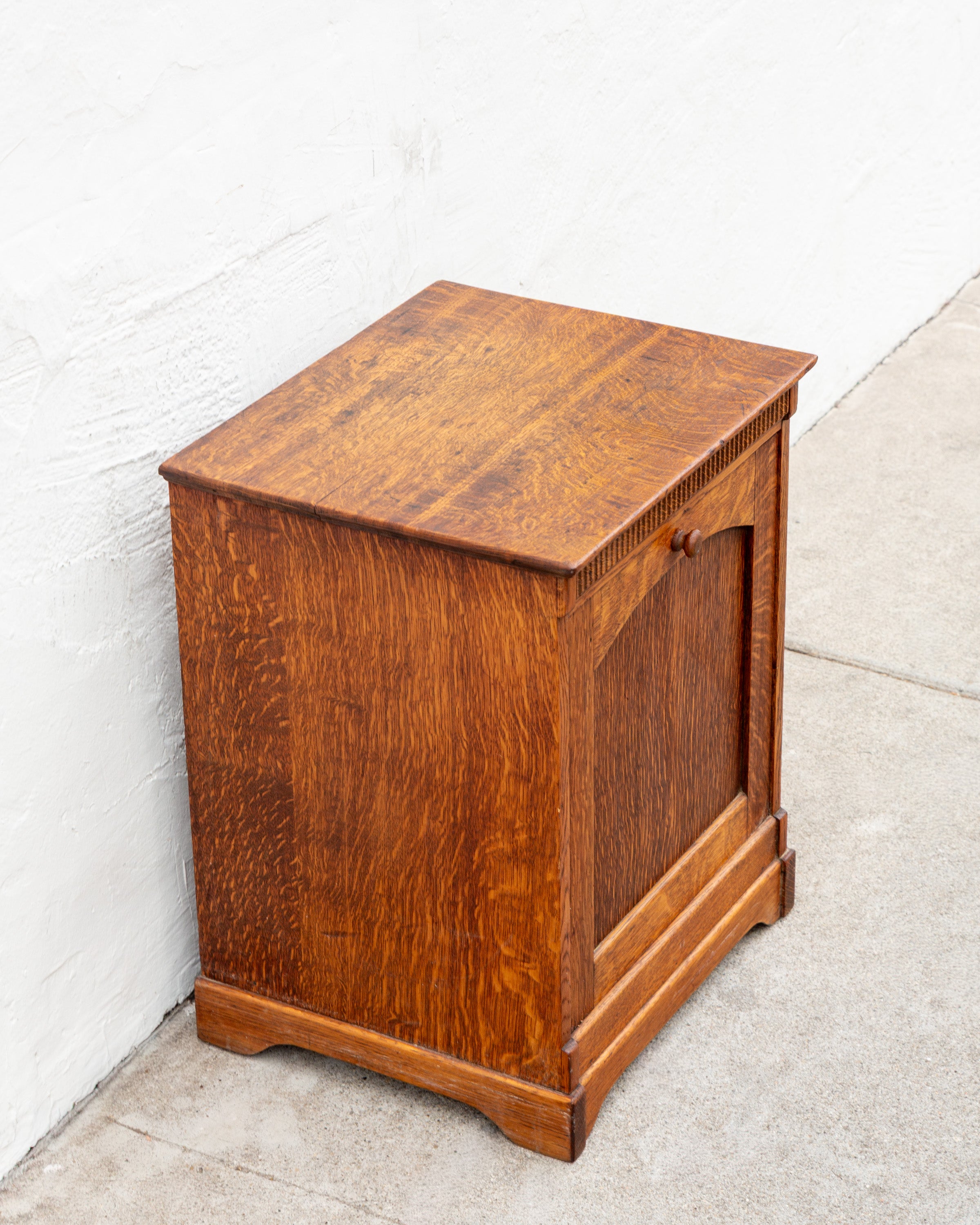 Three-quarter view from the opposite side of a quarter-sawn oak bin cabinet, showing the figured side panel.
