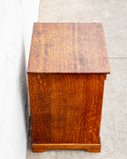 Elevated side view of a tiger oak bin cabinet showing the figured top boards and ray fleck in the side panel.
