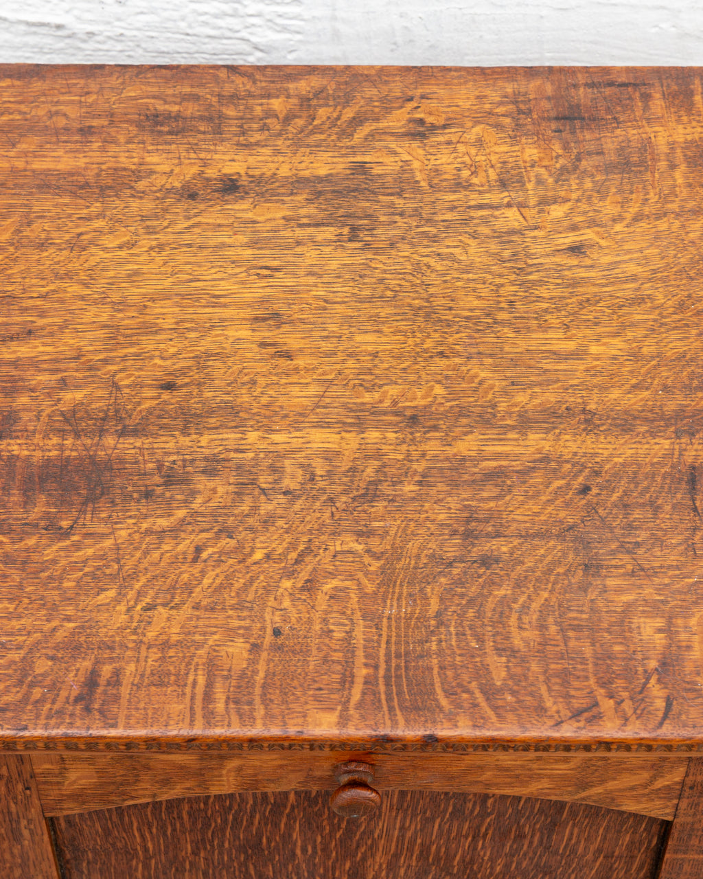 Detail of the cabinet top in quarter-sawn oak, showing heavy ray fleck figure, fine scratches and dark marks.