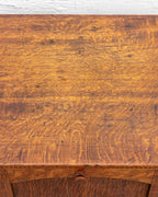 Detail of the cabinet top in quarter-sawn oak, showing heavy ray fleck figure, fine scratches and dark marks.