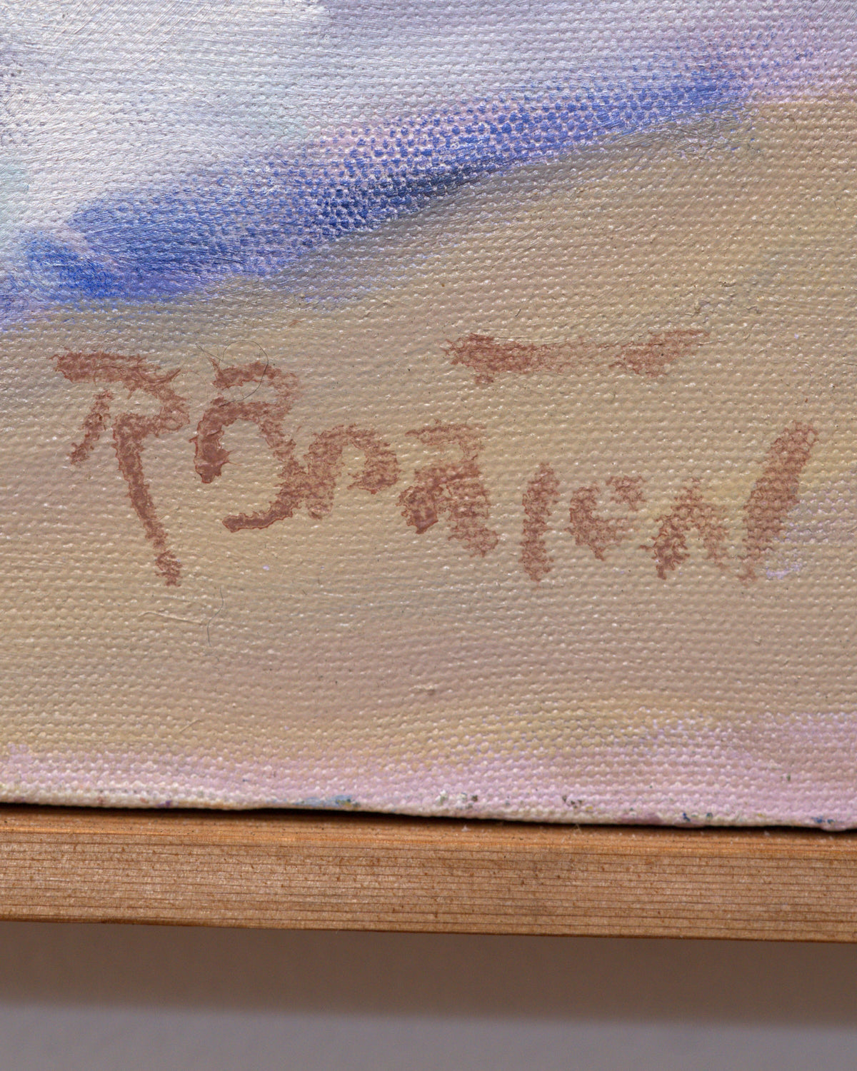 Detail of the artist signature in brown paint at lower right of the floral still life, above the wood frame edge.