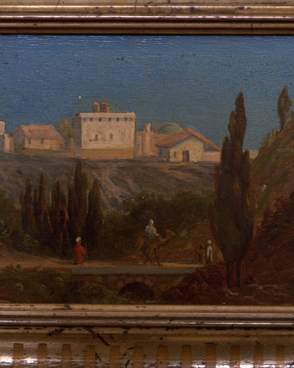 Close detail (villa) of the small Italian landscape of a hilltop villa and cypresses in a carved gilt and silver frame.