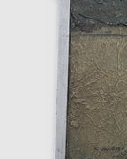 Side view of the frame edge on the Ray Jacobsen 1966 plaster relief abstract in slate blue, cream and olive in a silver strip frame.