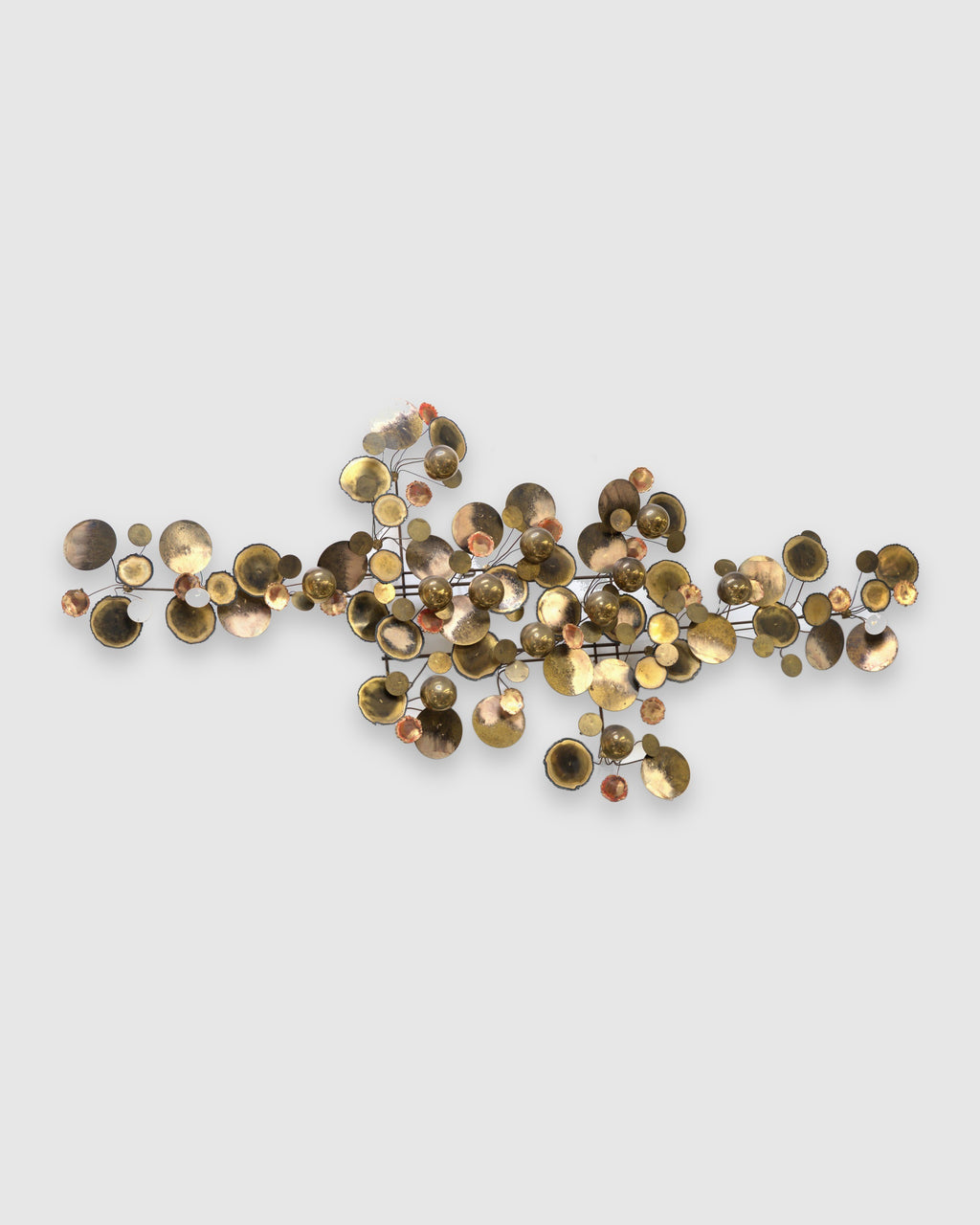 Straight-on view of a Curtis Jere Raindrops wall sculpture, dozens of torched brass discs, brass spheres and copper-toned cups on a black rod armature, on a light gray background.