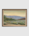 Straight-on view of a Joseph Knowles California desert landscape with lavender mountains and rabbitbrush in a gray frame with linen liner, on a light gray background.