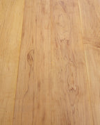 Close view of the grain and board seams on a solid maple tabletop.