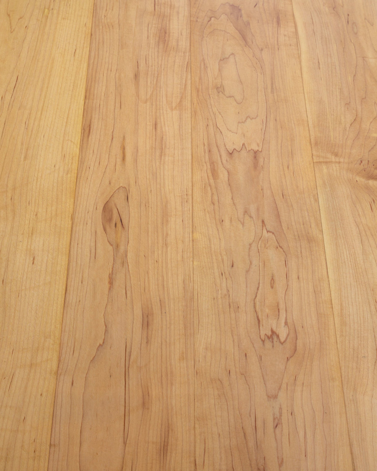 Close view of the grain and board seams on a solid maple tabletop.