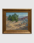 Straight-on view of a Jack McCartney desert landscape with a green smoke tree, sage and rose hills in a stepped gilt frame, on a light gray background.