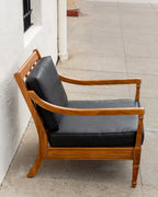 Side profile of the mid century arm chair showing the slatted back rail and the outward sweep of the back leg
