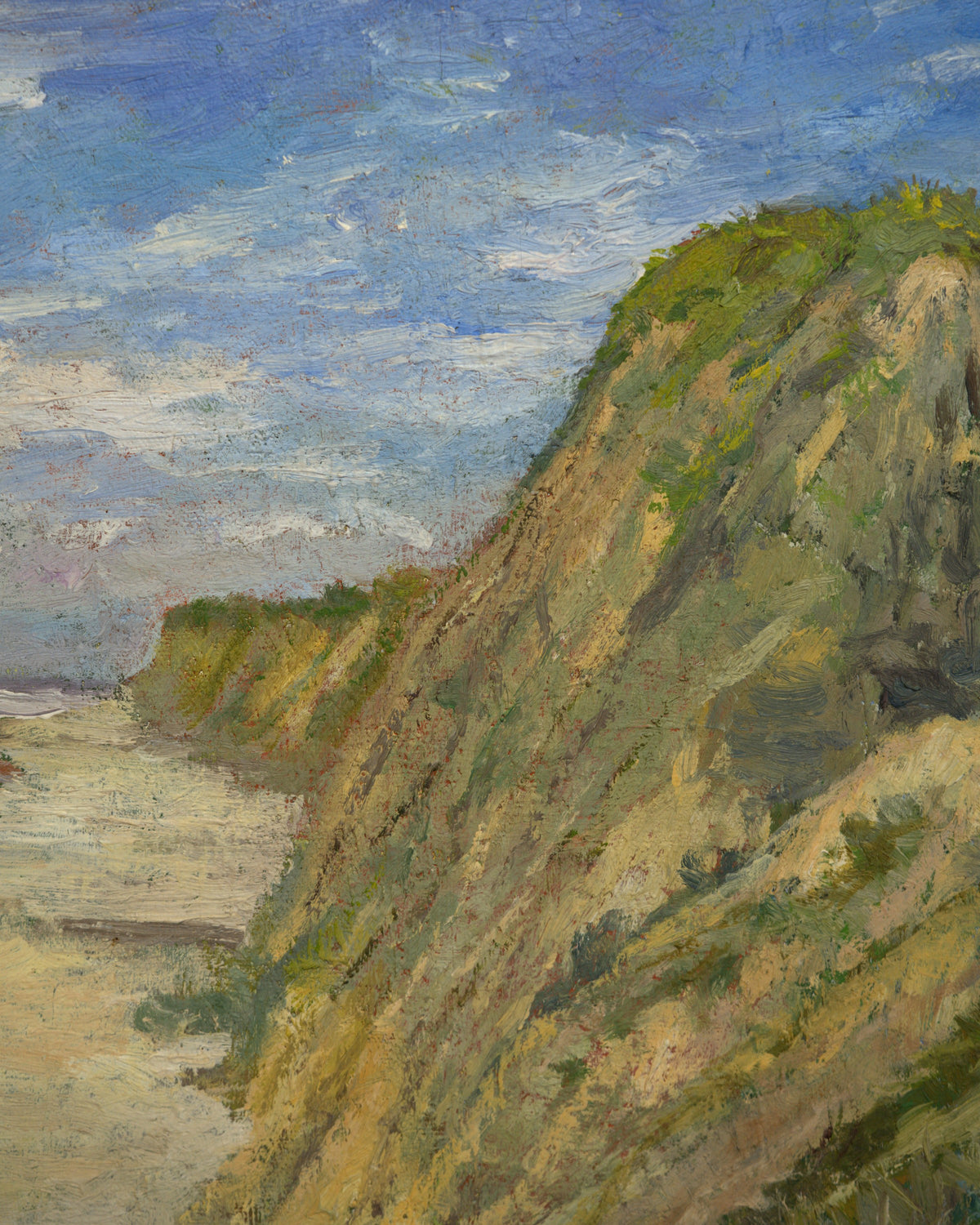 Close detail (bluff) of the John Modesitt painting of a golden coastal bluff and beach near San Diego in a light wood frame.