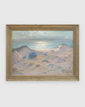Straight-on view of a Frank Montague Moore painting of sand dunes with blue lupine and a silver sea in a ribbed gilt frame, on a light gray background.