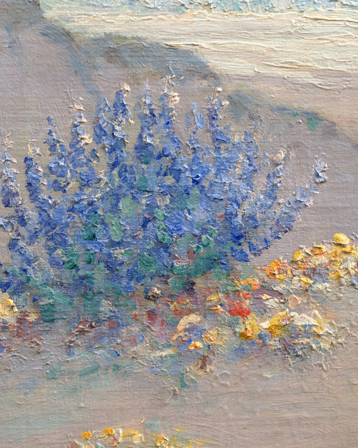 Close detail (lupine) of the Frank Montague Moore painting of sand dunes with blue lupine and a silver sea in a ribbed gilt frame.