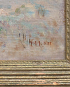Detail of the signature on the Frank Montague Moore painting of sand dunes with blue lupine and a silver sea in a ribbed gilt frame.