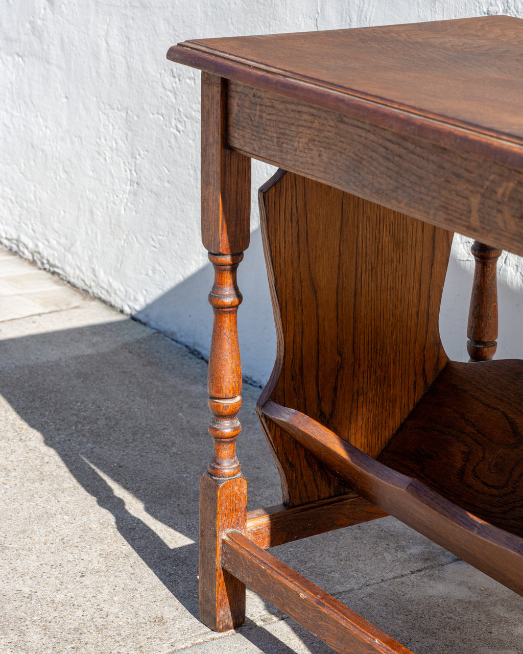 Detail of the molded oak top edge, turned leg and end panel of a side table