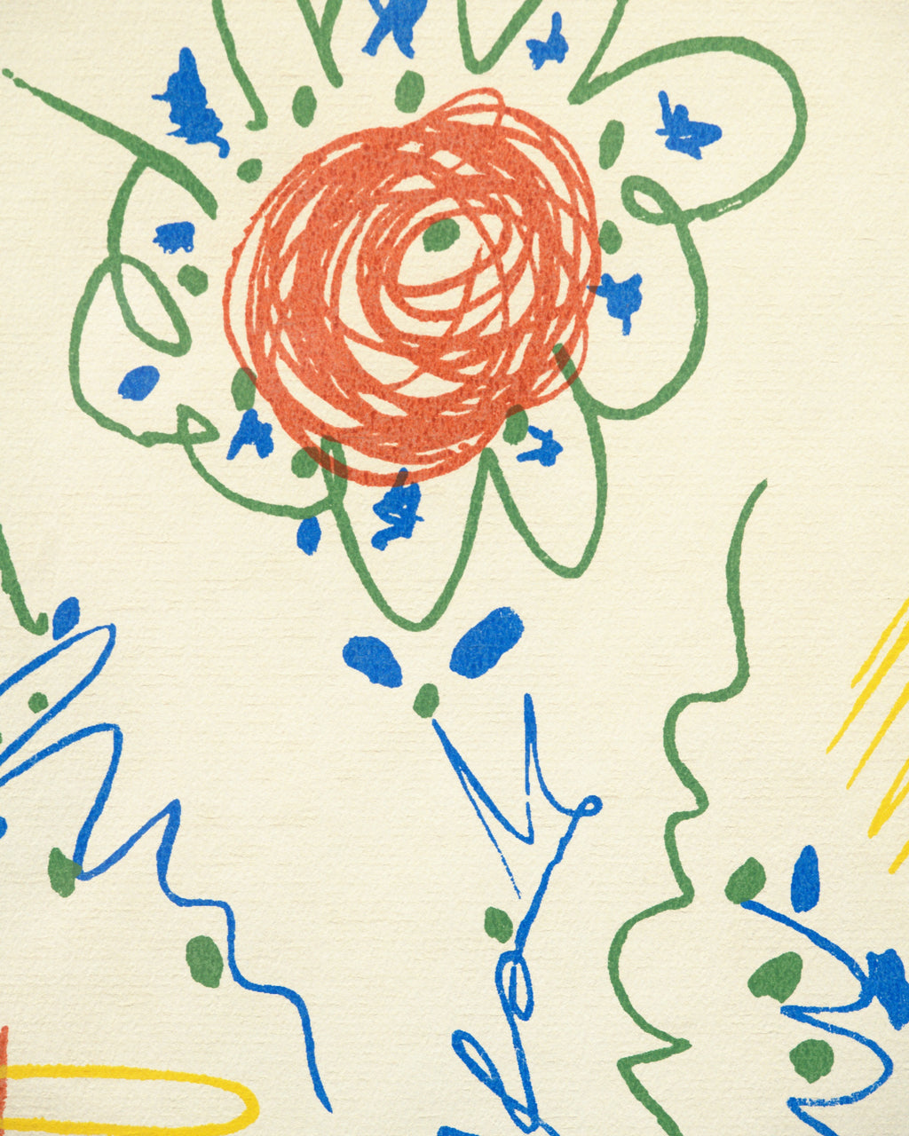 Detail of the red-orange scribbled blossom ringed by green petals and blue marks in the Picasso flower lithograph.