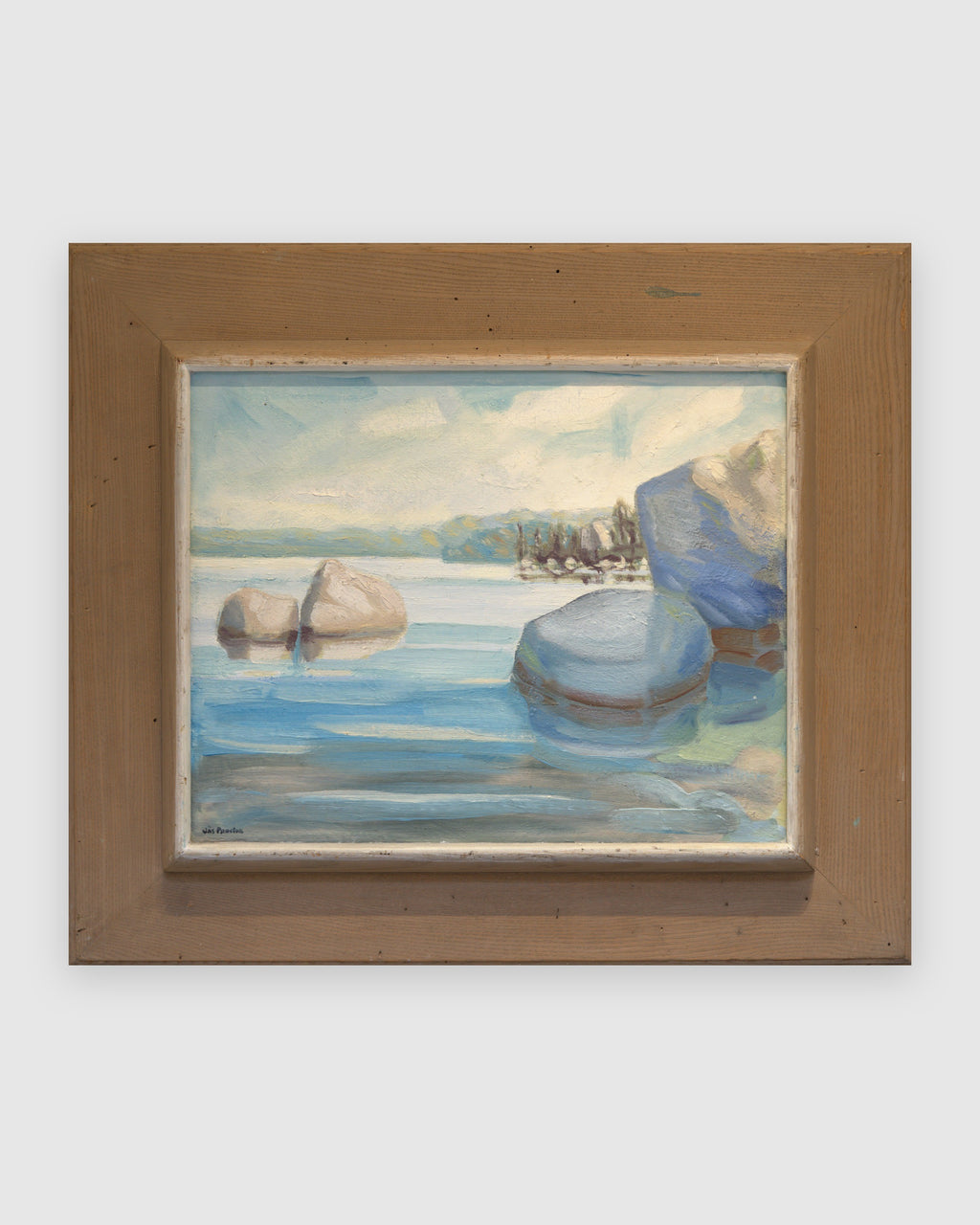 Straight-on view of a James Proctor painting of granite boulders in Lake Tahoe in a wide natural wood frame, on a light gray background.
