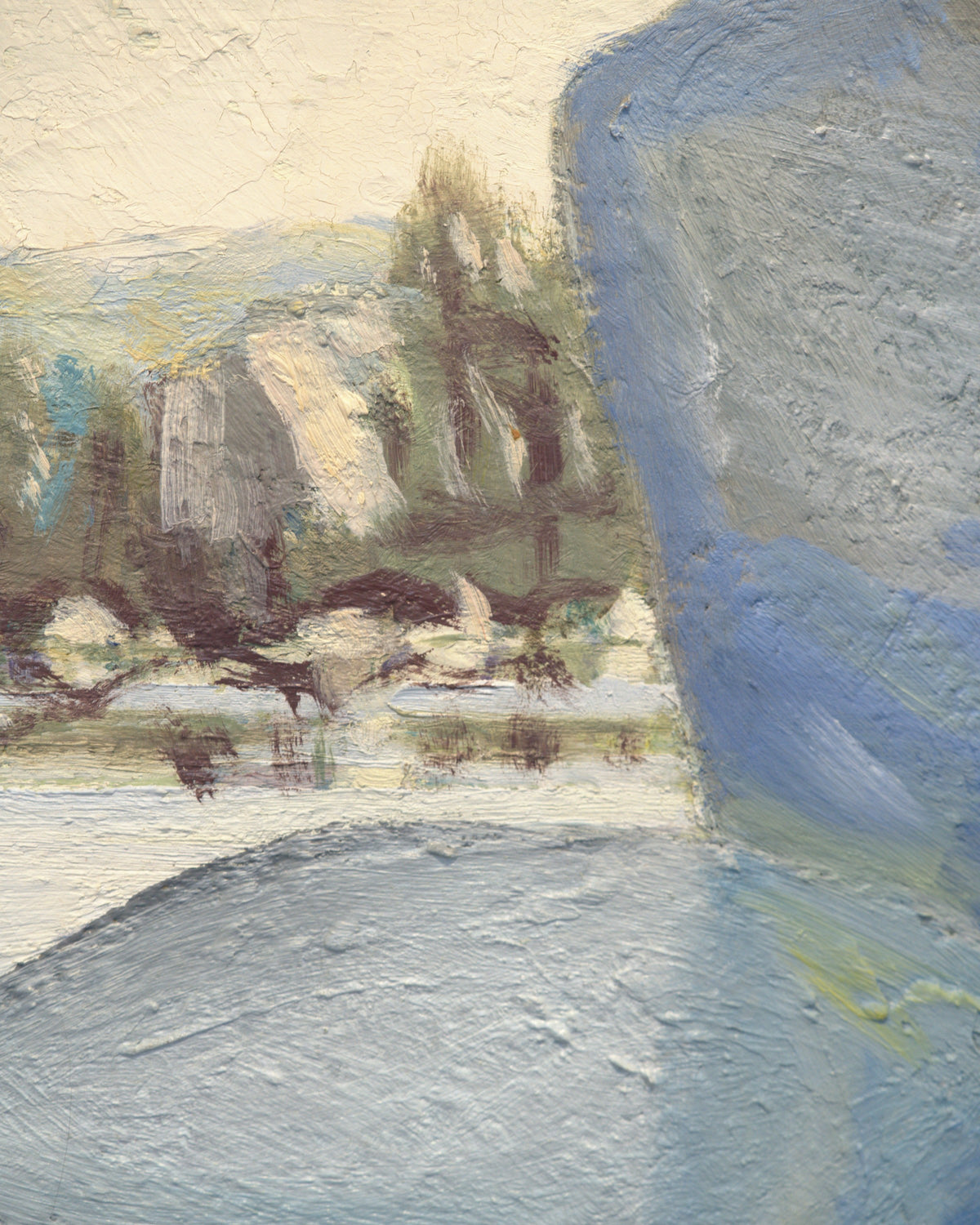 Close detail (shore) of the James Proctor painting of granite boulders in Lake Tahoe in a wide natural wood frame.