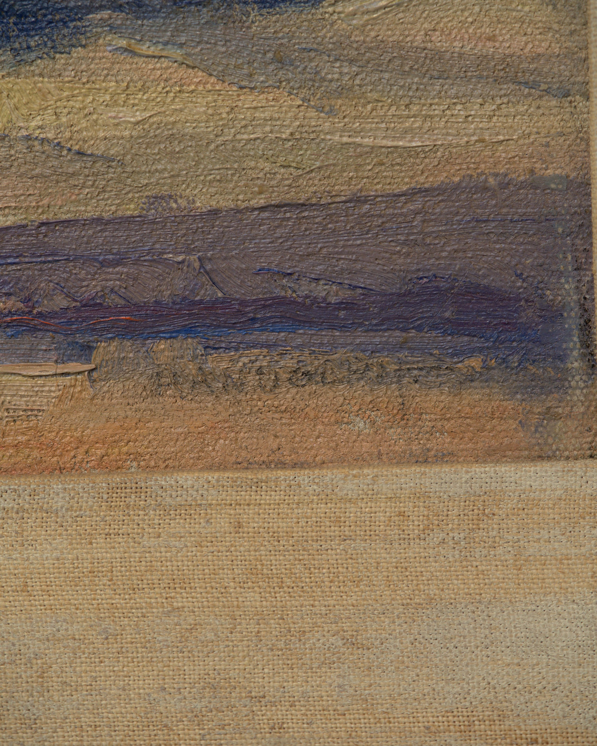Detail of the signature on the Lee Fritz Randolph painting of a blue snow-streaked mountain range above an ochre plain in a natural wood frame.