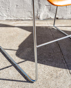 Close-up of the chromed steel rod sled legs and stretcher of a 40/4 stacking chair