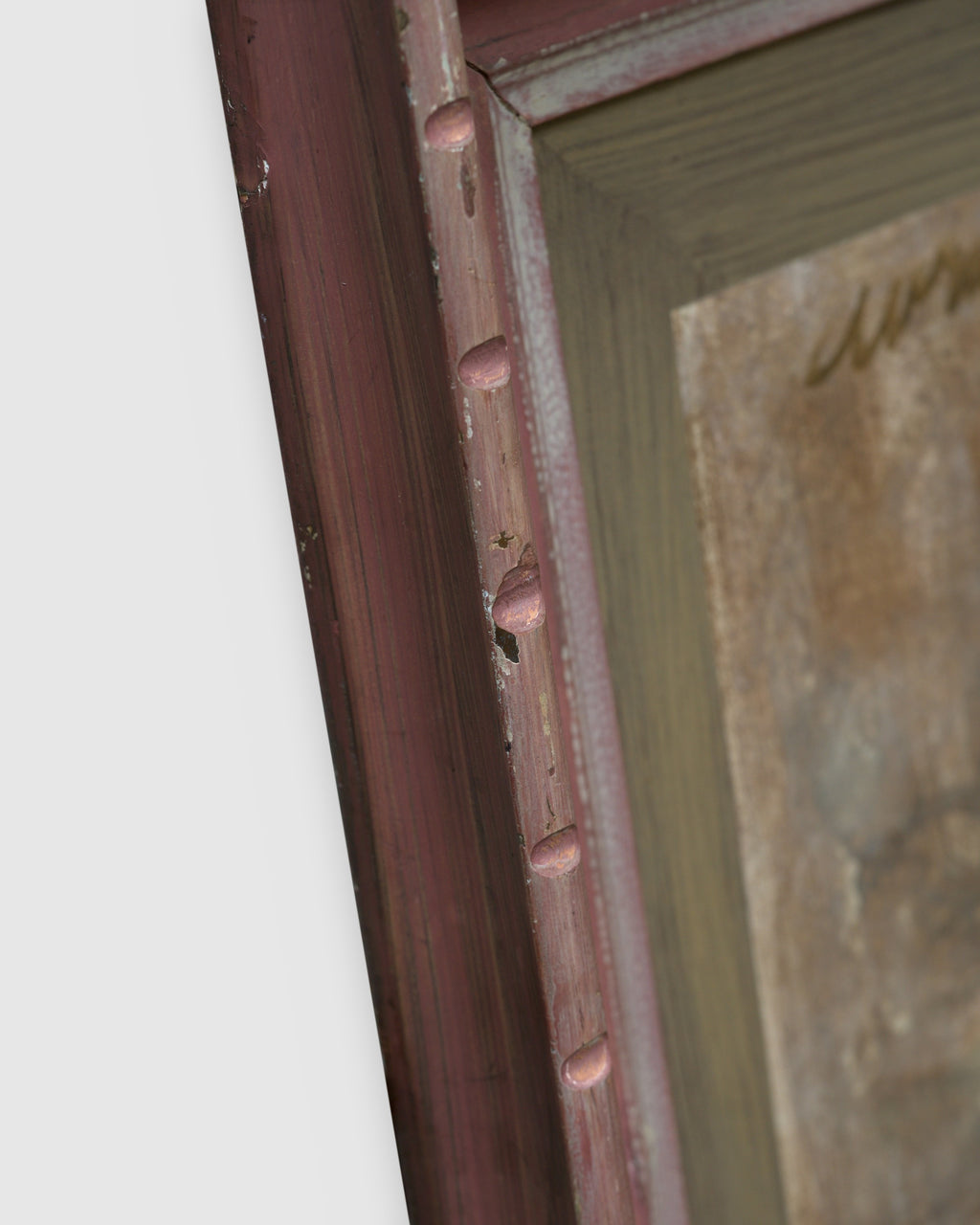 Angled view showing the frame depth of the Avram Rubenstein abstraction of a pale bird in chalky white and rust in a pink bamboo-style frame.