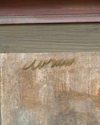Detail of the signature on the Avram Rubenstein abstraction of a pale bird in chalky white and rust in a pink bamboo-style frame.