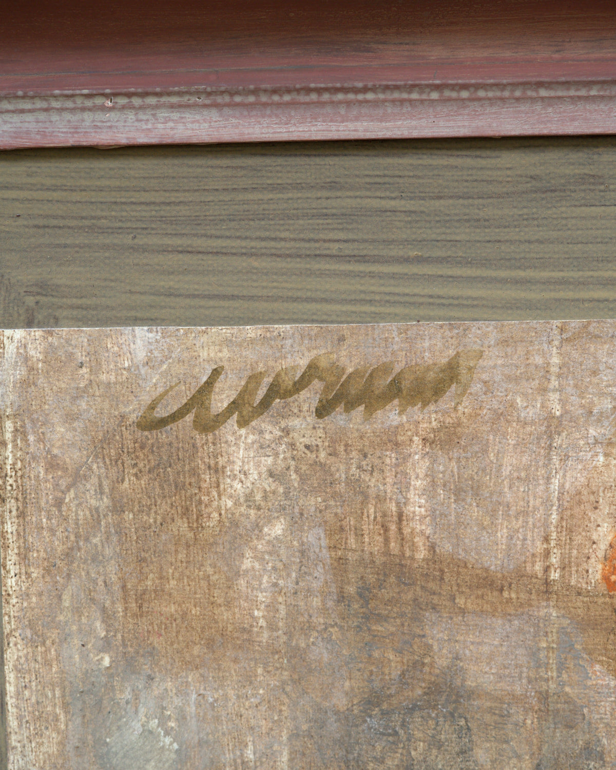 Detail of the signature on the Avram Rubenstein abstraction of a pale bird in chalky white and rust in a pink bamboo-style frame.