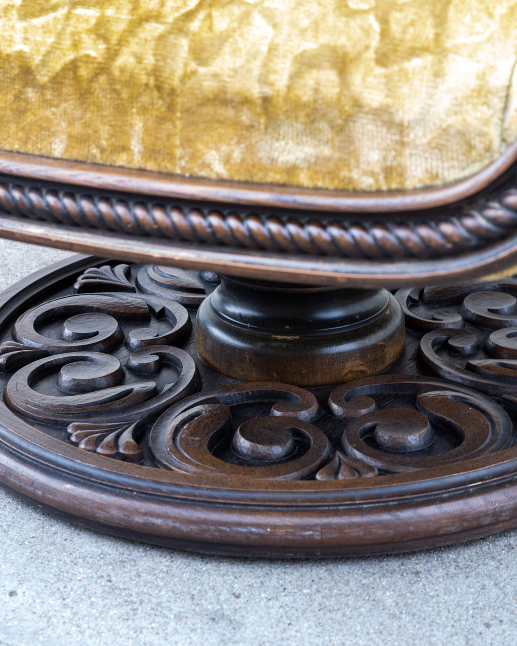 Detail of the seat edge with its carved rope twist molding above the turned column and pierced scrollwork pedestal base