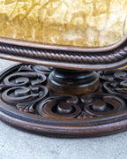 Detail of the seat edge with its carved rope twist molding above the turned column and pierced scrollwork pedestal base