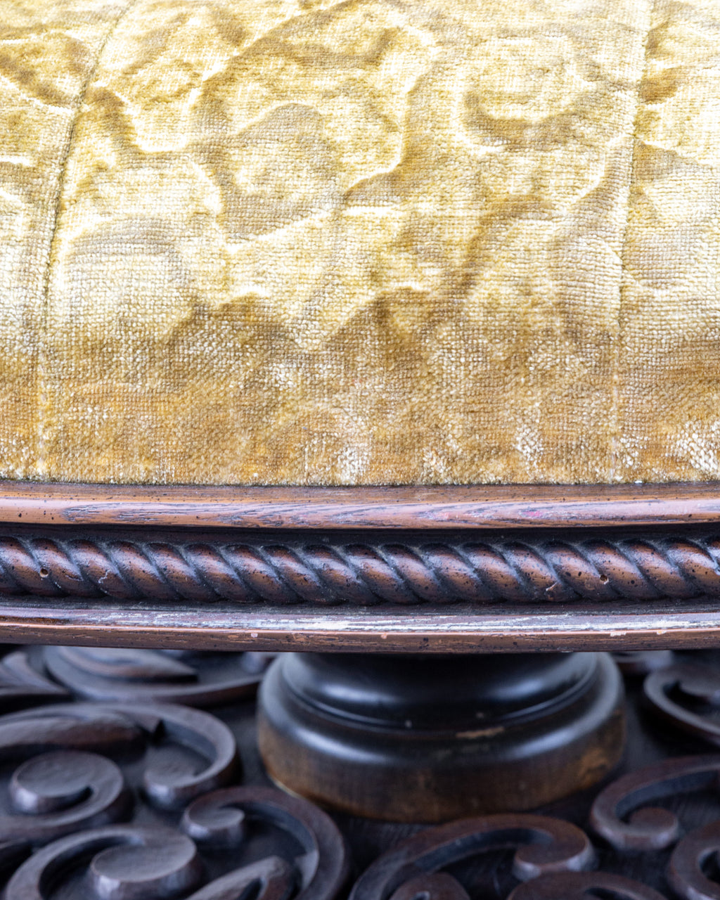 Detail of the gold velvet above the carved rope twist band and the turned column of the pedestal base