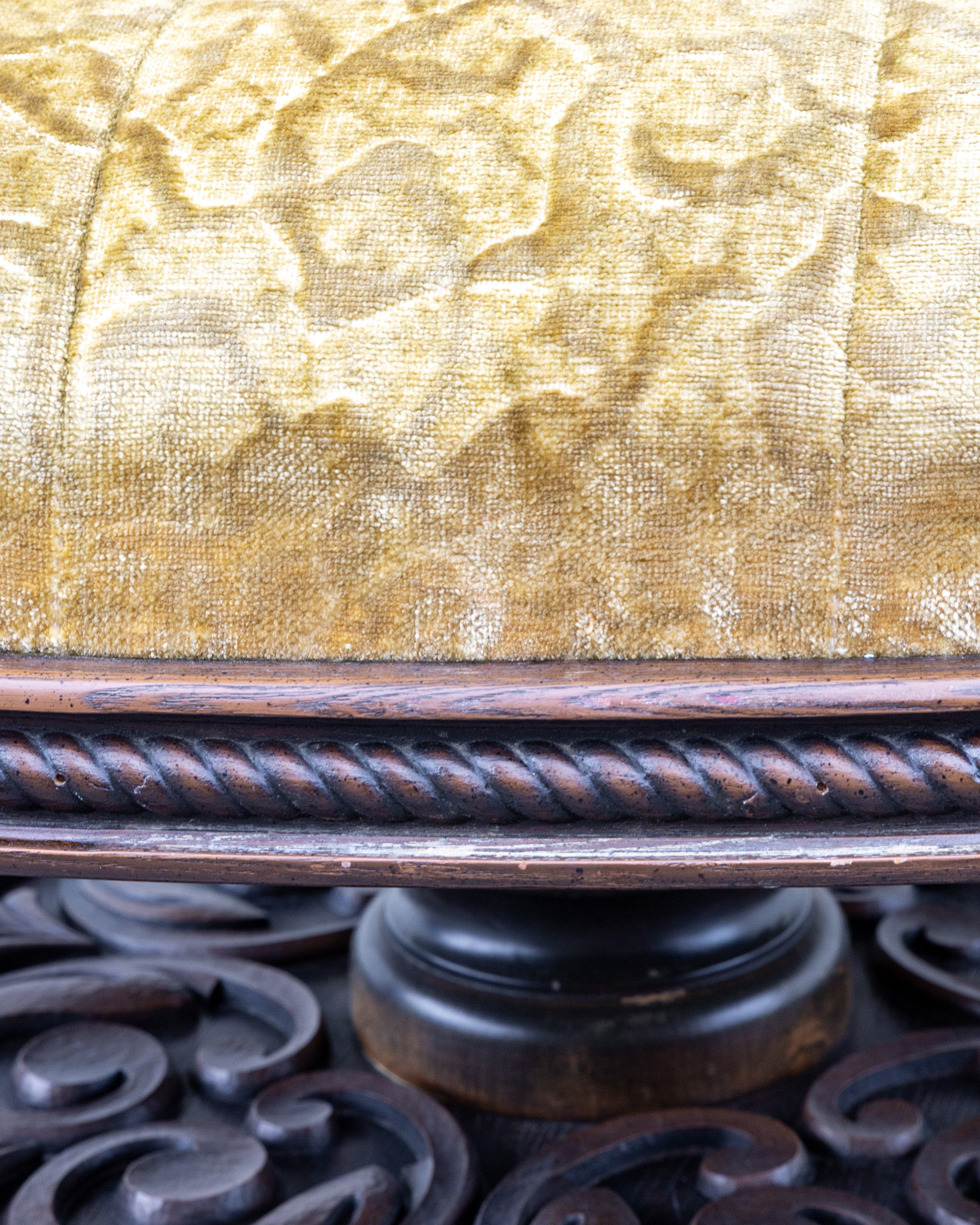 Detail of the gold velvet above the carved rope twist band and the turned column of the pedestal base