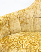 Close detail of the button tufting and the crushed nap of the gold damask velvet