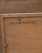 Back of the Milford Zornes painting Hills of Nipomo, with the title written in marker on the backing board.